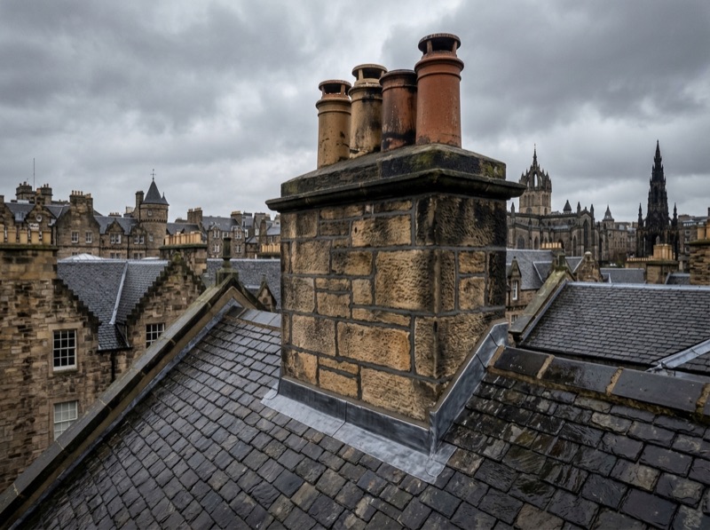 Repointed stone chimney stack with new lead flashing