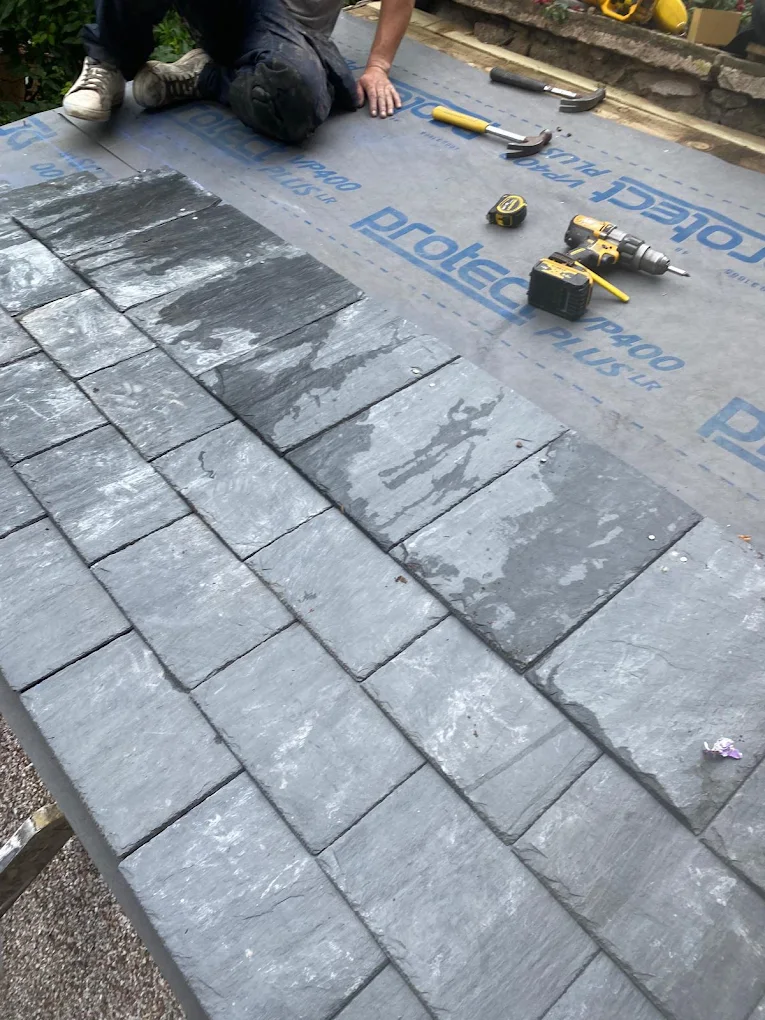 New slates being fitted over breathable membrane